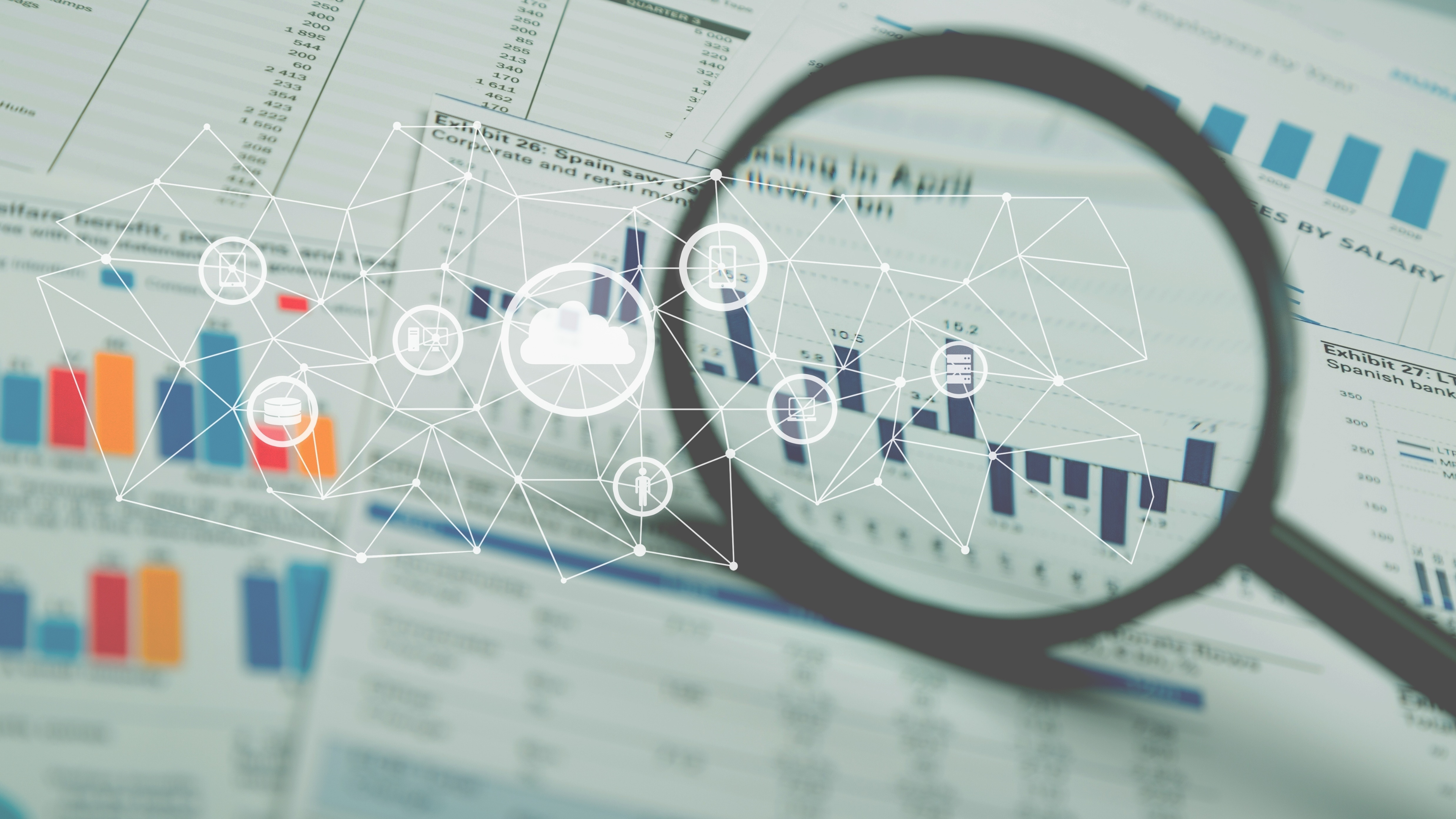 magnifying glass and graphs